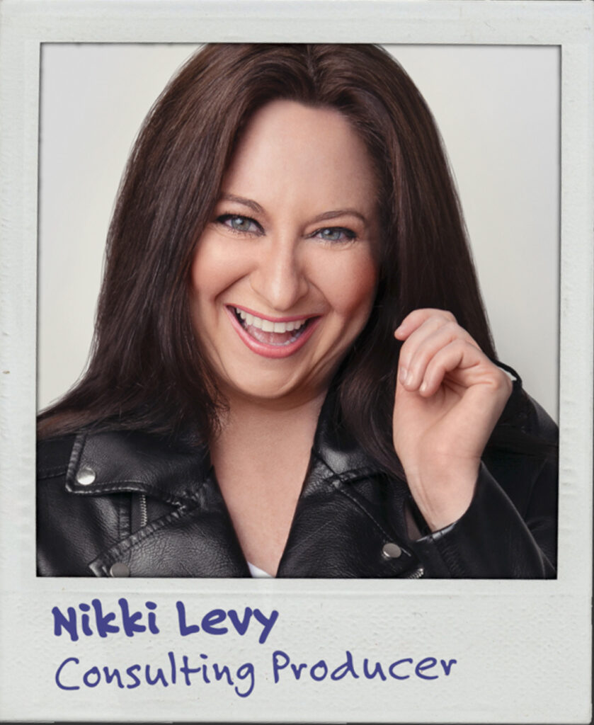 Portrait of a white woman with long, brown hair and a leather jacket, smiling cheekily at the camera. The text below reads: Nikki Levy. Consulting producer.
